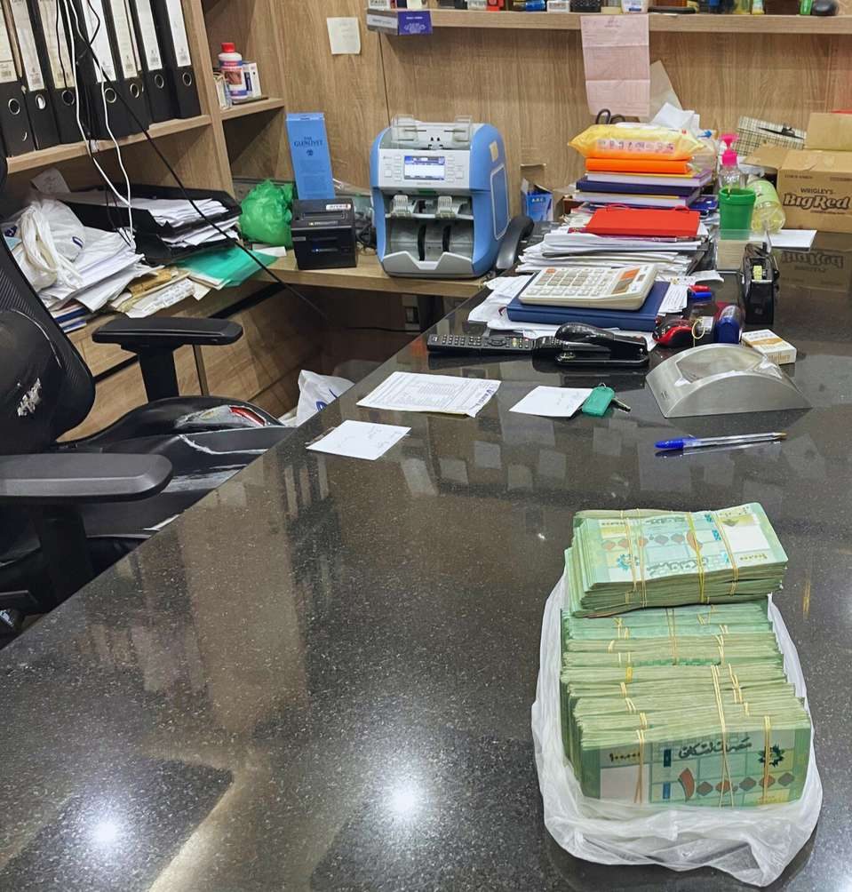 Stacks of banknotes on an office desk