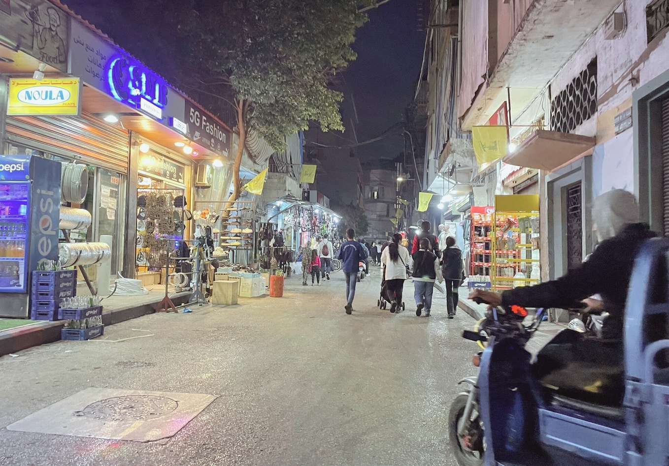 A busy market street at night